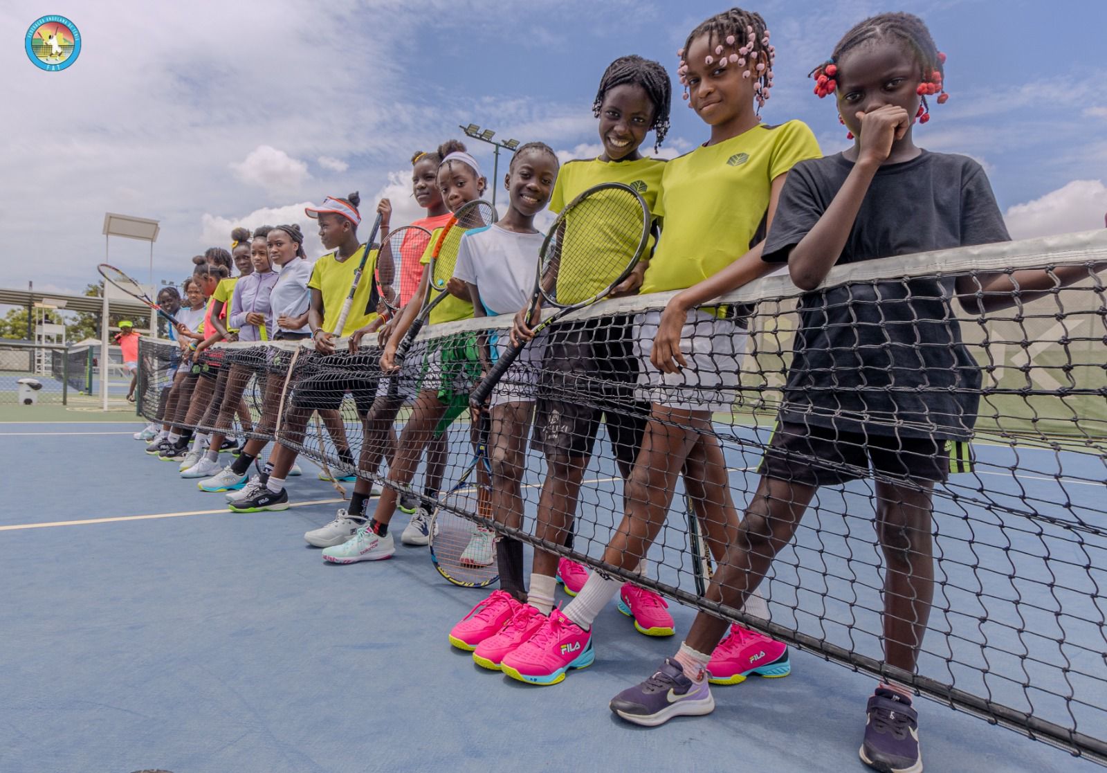Young boys in Angola holding their new tennis rackets